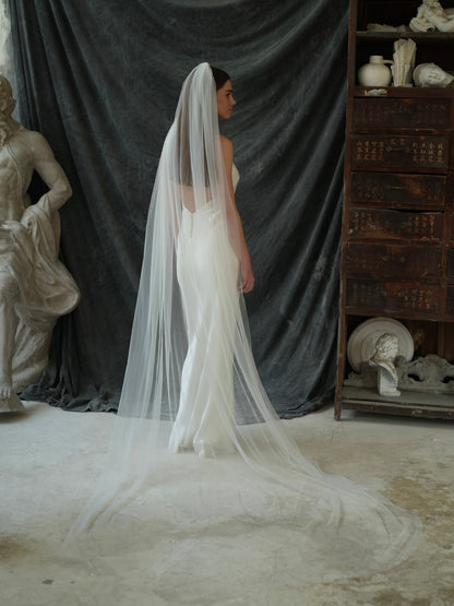 Back view of woman wearing a simple plain classic veil, cathedral length, single tier in full coverage