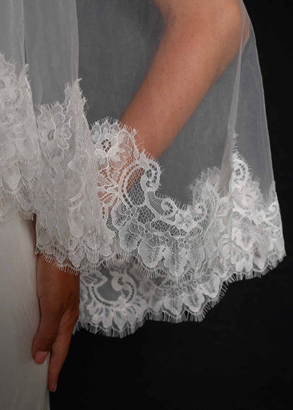 Close-up of a short lace veil, two tier, fingertip length